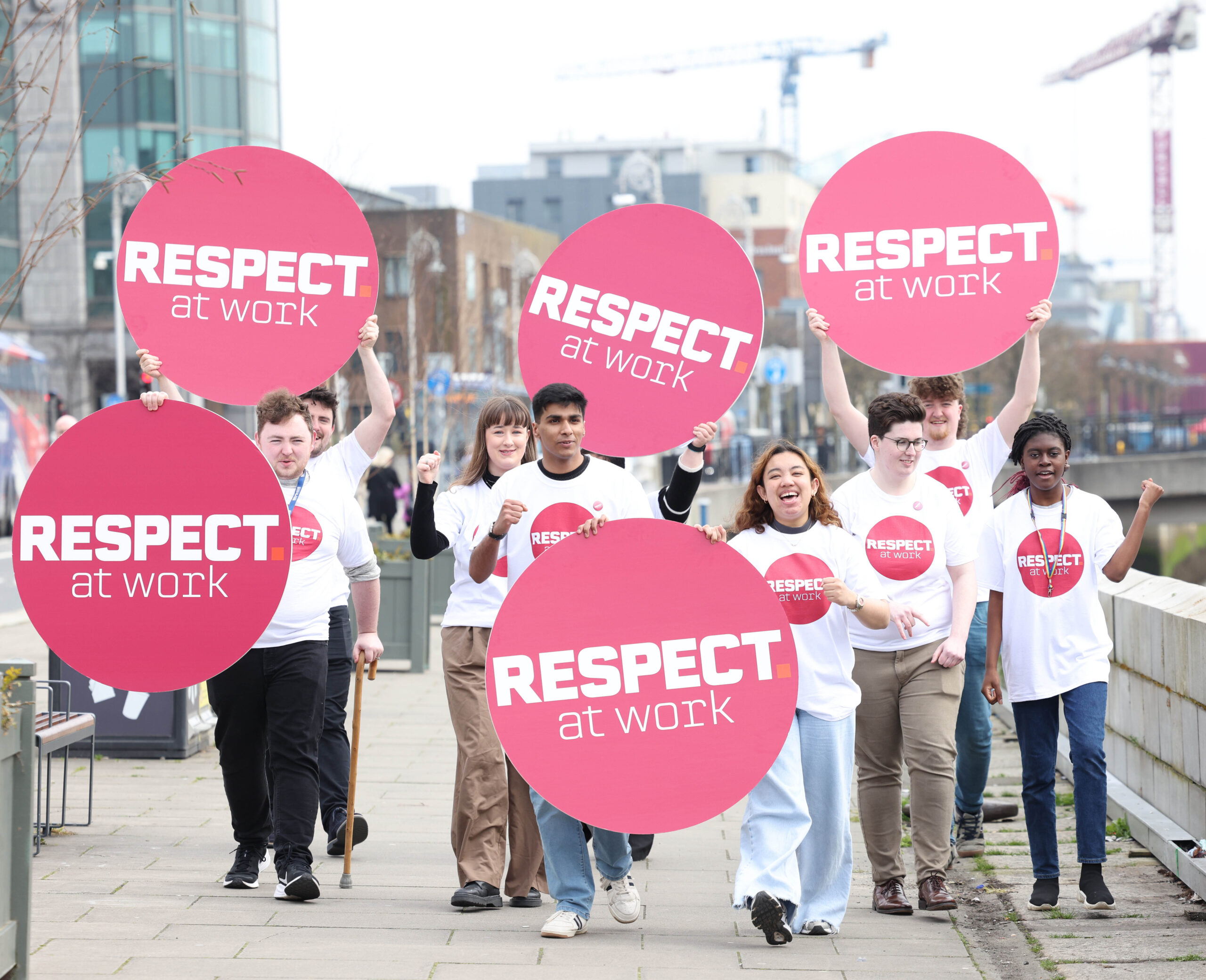 Photo of a group of people holding respect at work signs