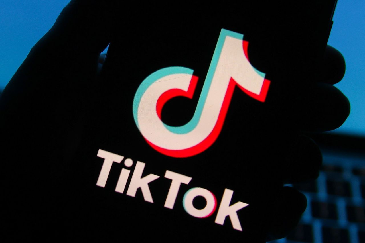 image of tiktok logo and name on an iphone